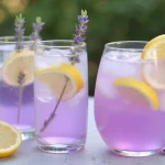 Floral Lavender Lemonade Spritz in glasses garnished with lemon slices and lavender
