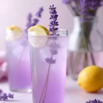 Lavender Lemonade Spritz in glasses garnished with lemon slices and fresh lavender